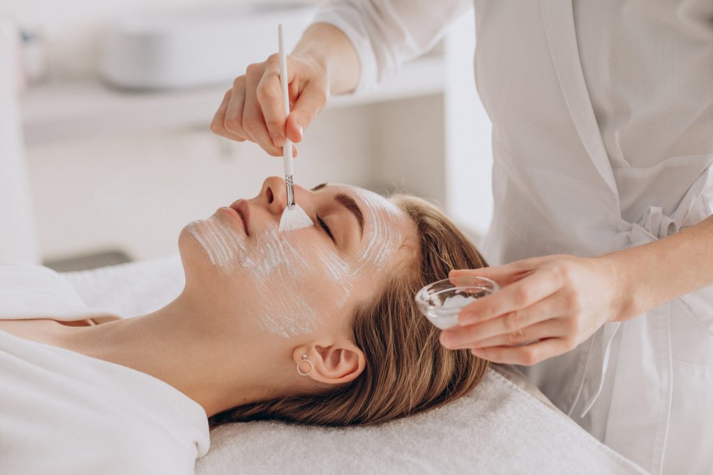 Woman receiving facial skincare treatment